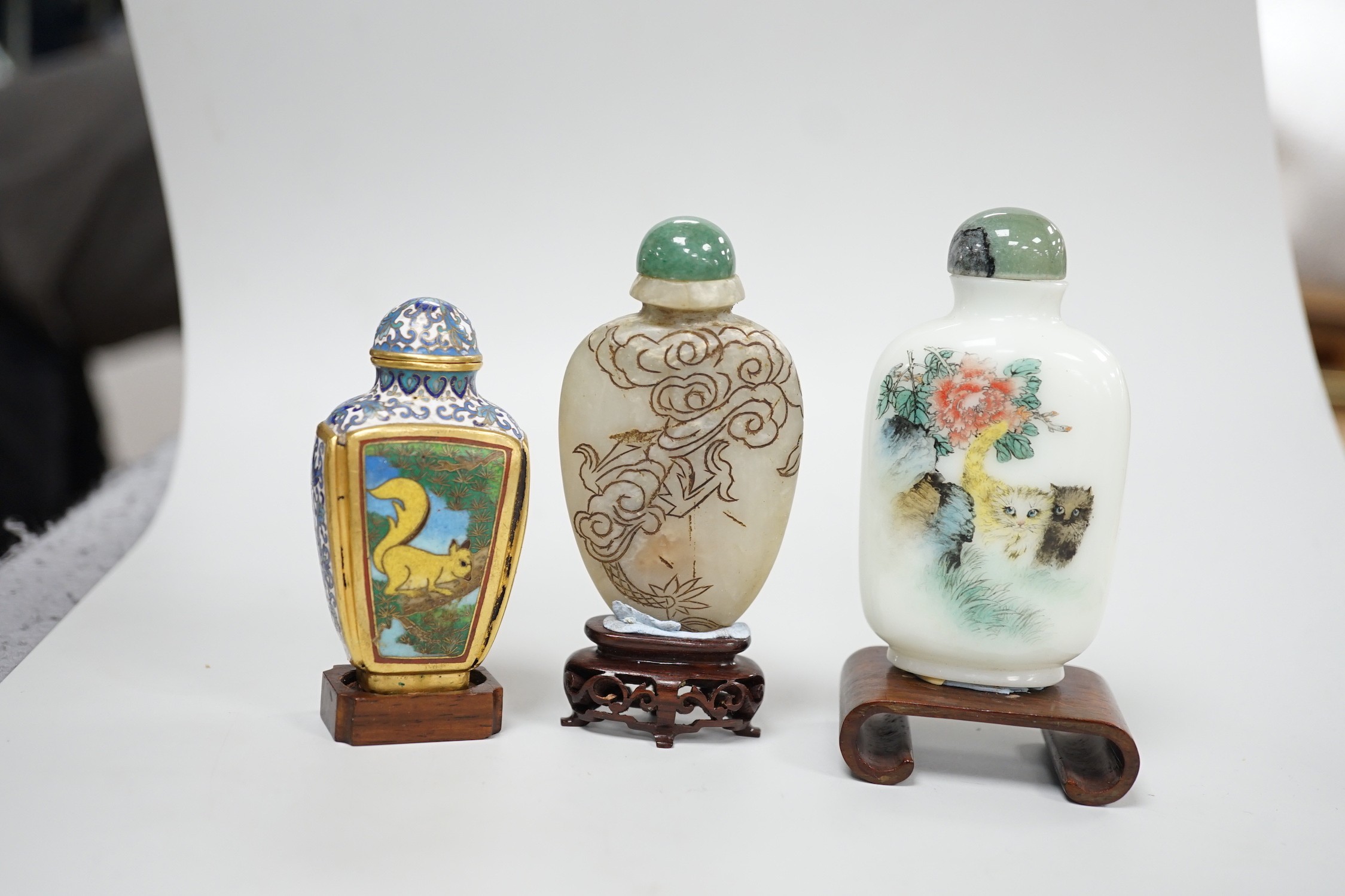 A Chinese cloisonné enamel snuff bottle, enamelled glass and stone snuff bottles. Tallest 8cm (3)